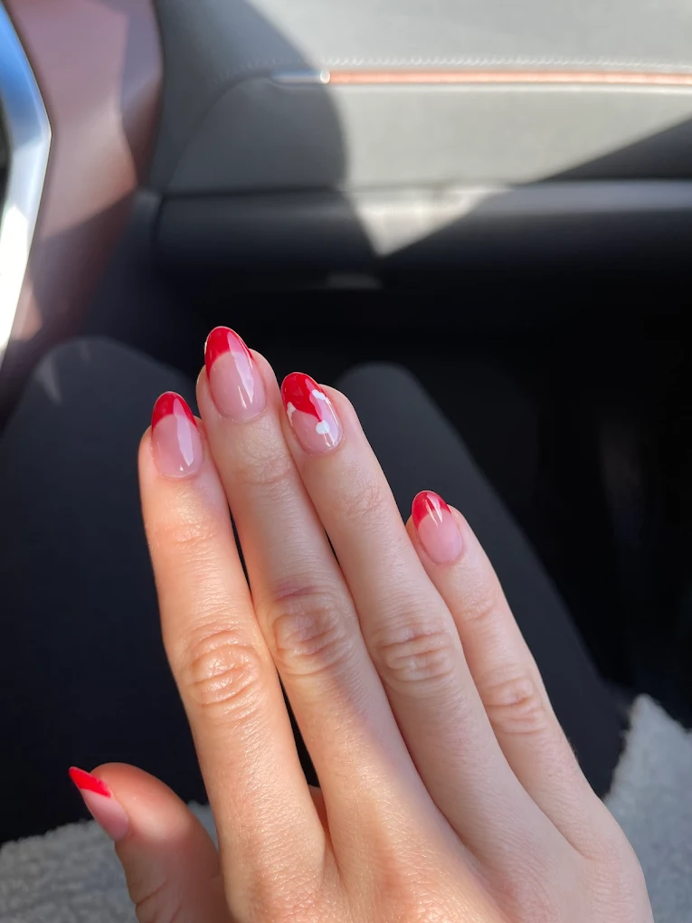Red French tip nails with curved smile line